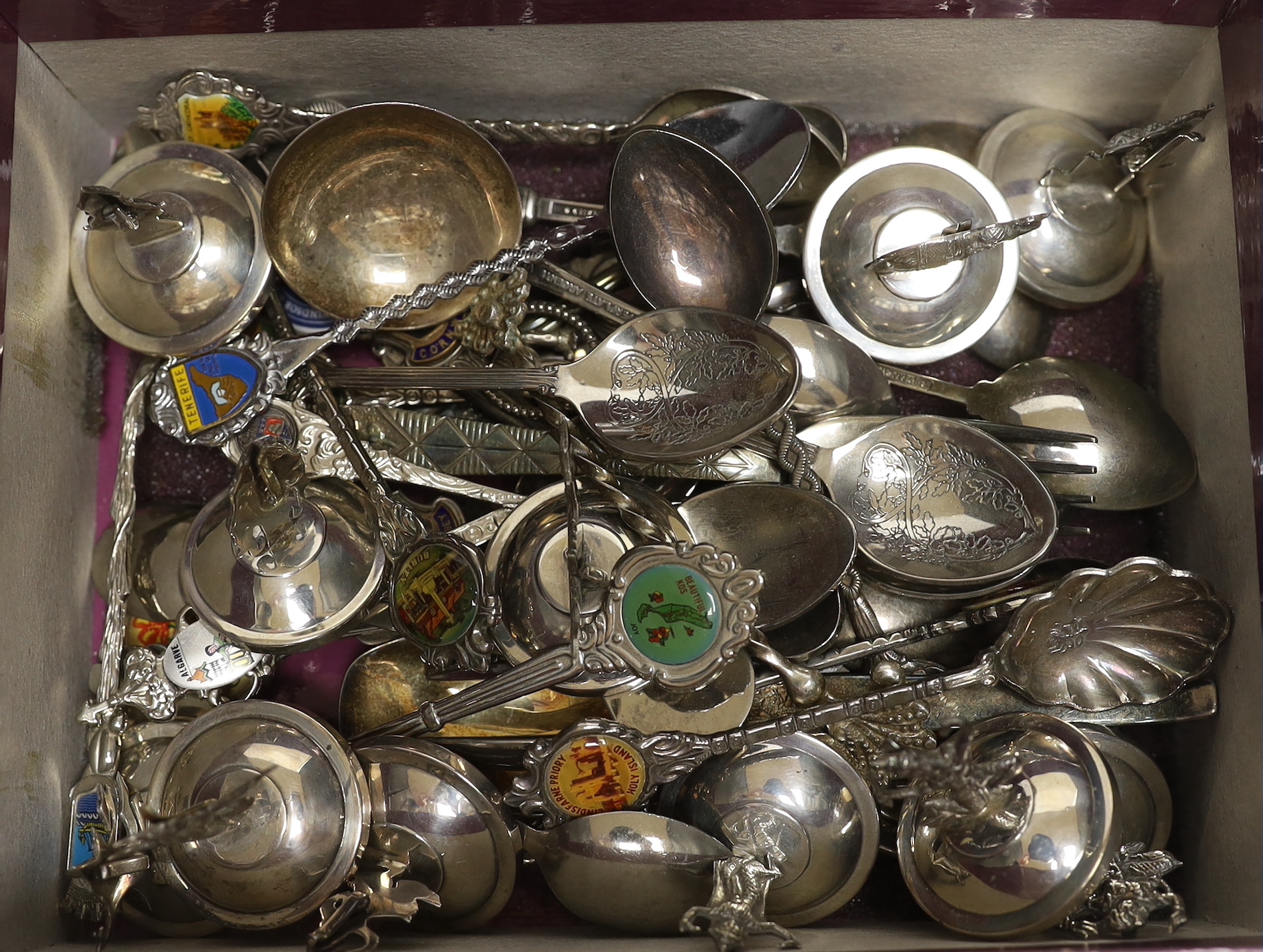 Twelve assorted Thai sterling mounted or 925 mounted menu holders, base diameter 36mm and a large quantity of plated or base metal flatware including souvenir spoons.